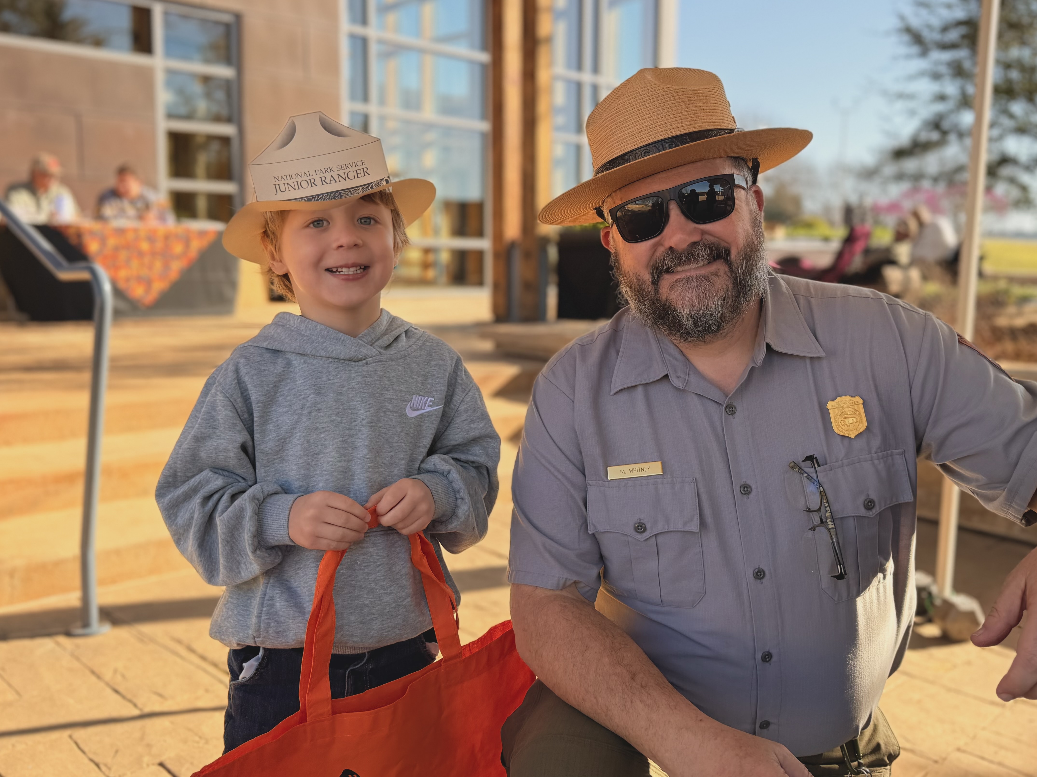 Gus with Junior Ranger hat meeting Park Ranger M. Whitney
